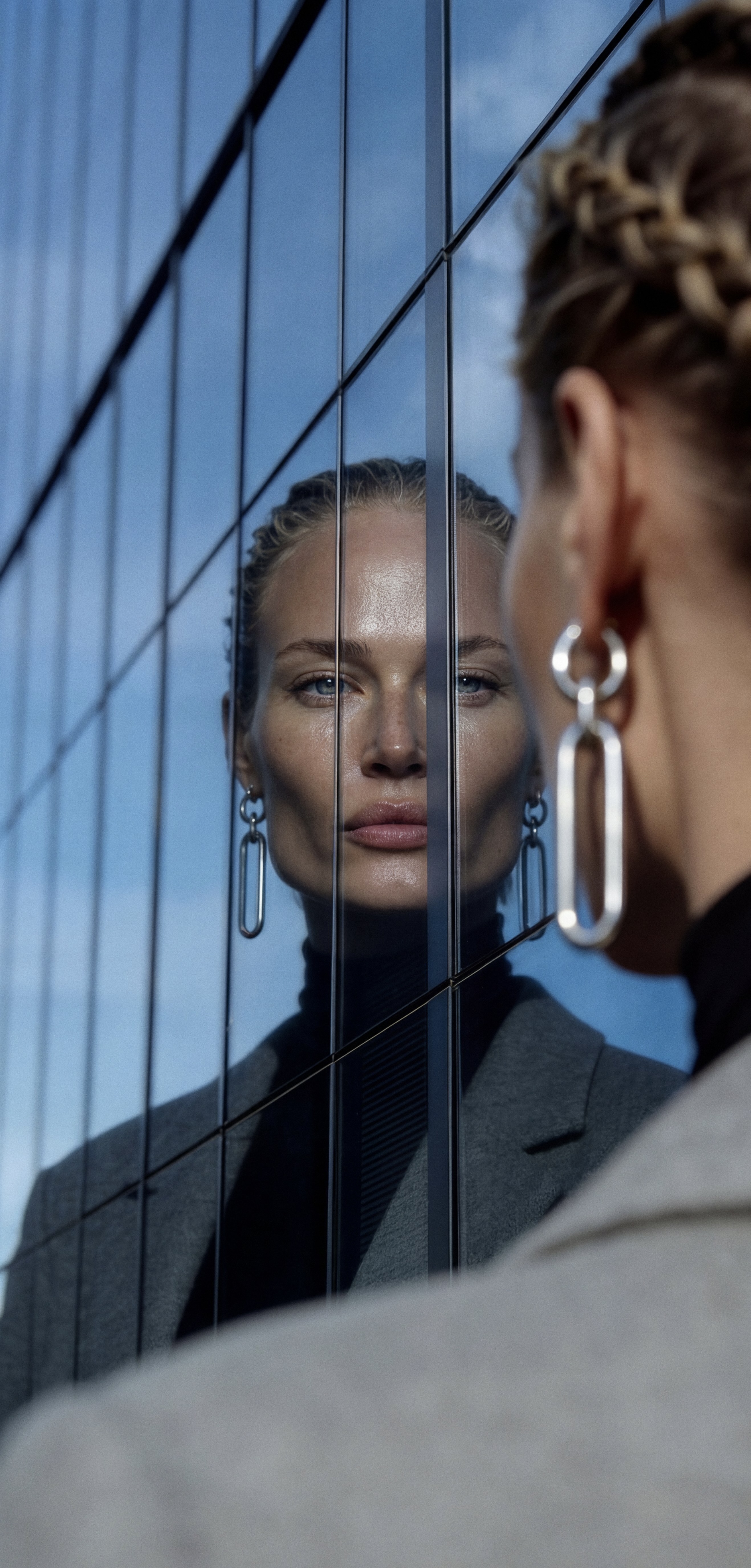Jewels in Motion — earring reflected in glass facade