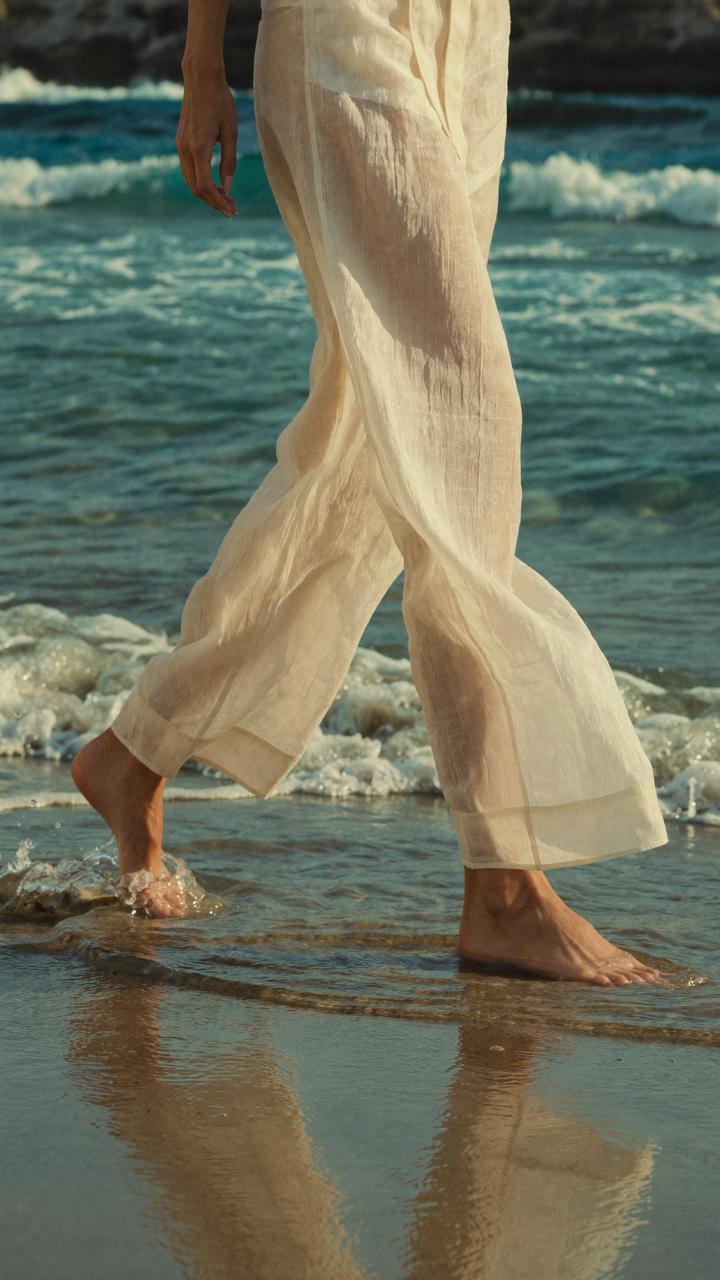 Written in the Tide — close-up walking through the surf