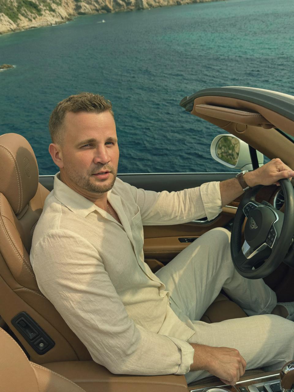 Written in the Tide — character in convertible car by the coast